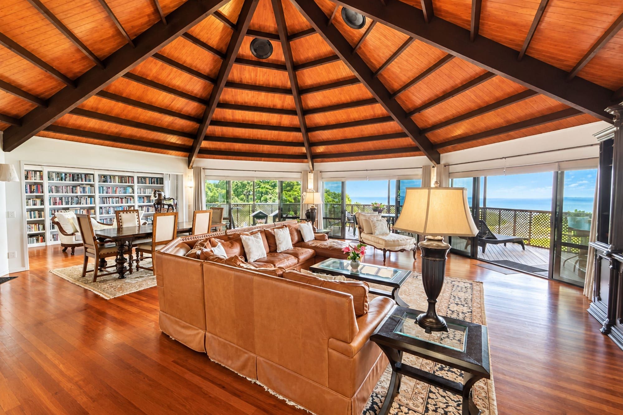 Octagonal great room with soaring timber ceiling, leather lounge and ocean-view decks, Muri, Rarotonga, Cook Islands